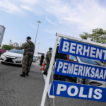 johor police at roadblocks catching traffic offenders