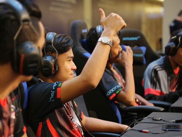 Malaysian youth playing e-sports in a tournament