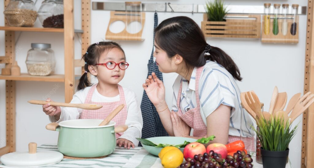 child cooking with mother