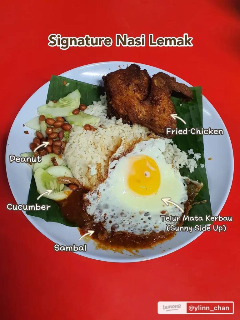 Signature Nasi Lemak with fried chicken, egg, sambal and fried anchovies