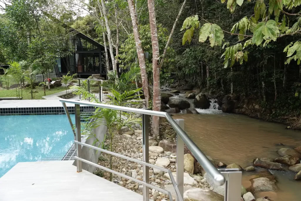outdoor pool and nature stream at durian farm stay