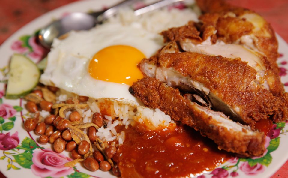runny eggs and juicy fried chicken with nasi lemak