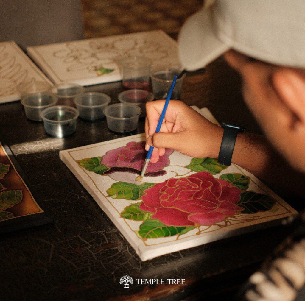 a visitor in Temple Tree Resort Langkawi Malaysia doing batik painting, capturing a part of the malaysian history 