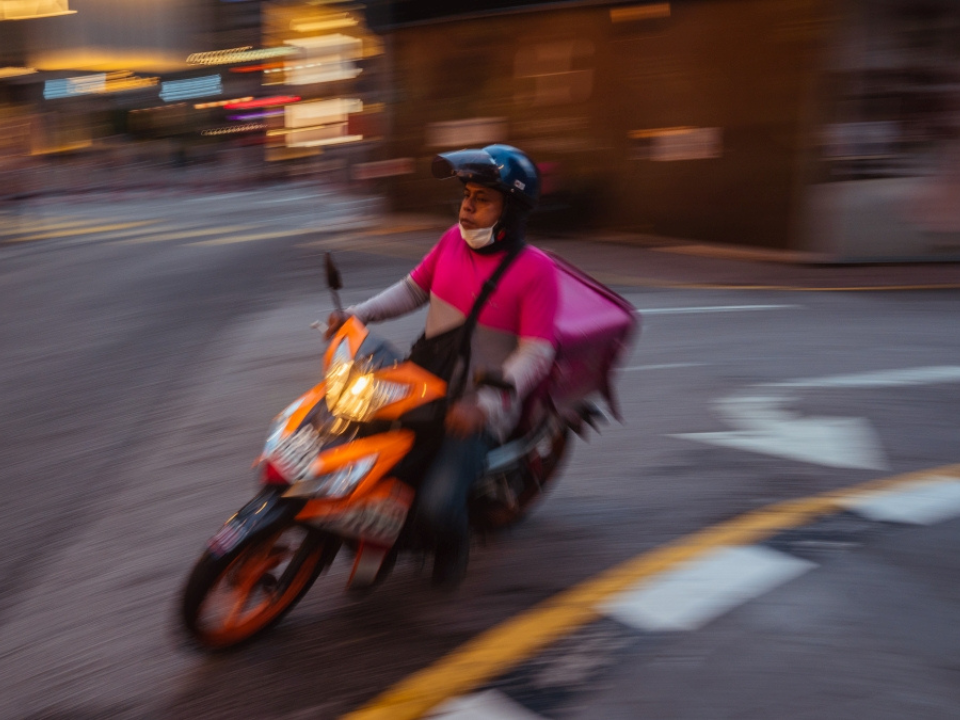 foodpanda delivery rider driving with a motorbike