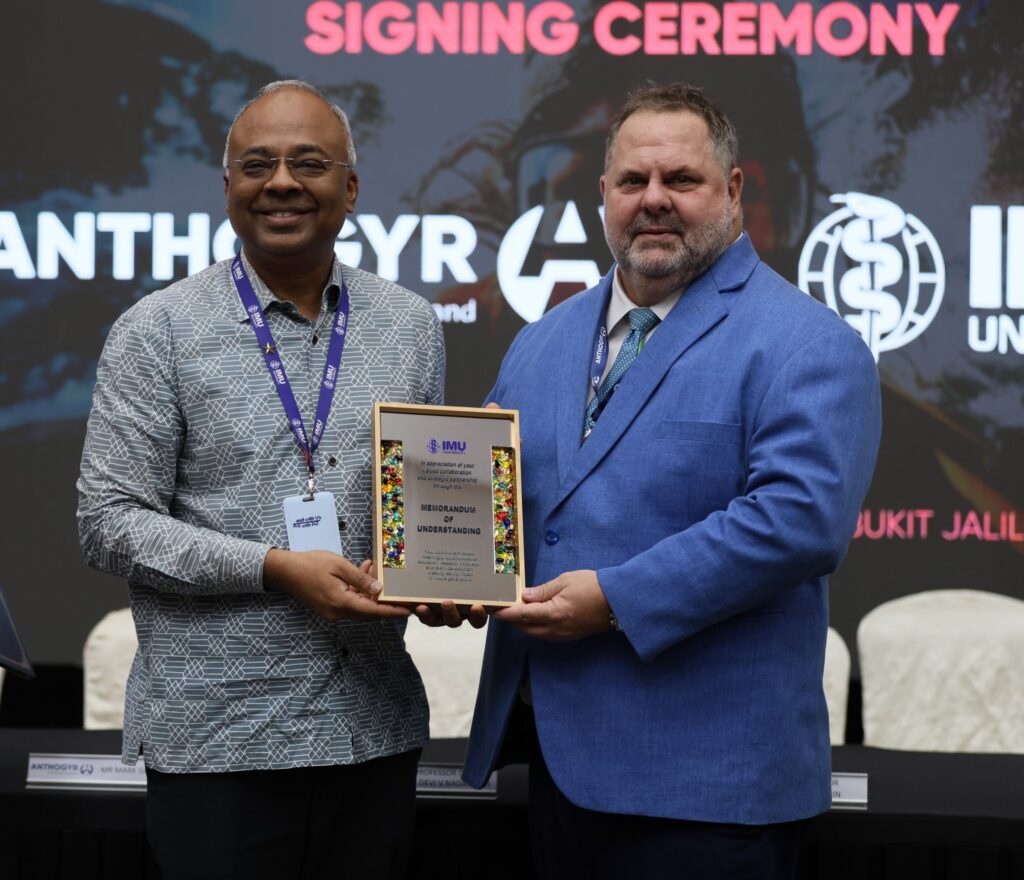 Prof Gerard George of IMU University and Mark Graham of Straumann Group holding the MoU plaque