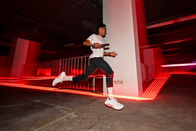 Runner carrying a relay baton in adidas Hyperboost Edge shoes at adidas Hyperrelay