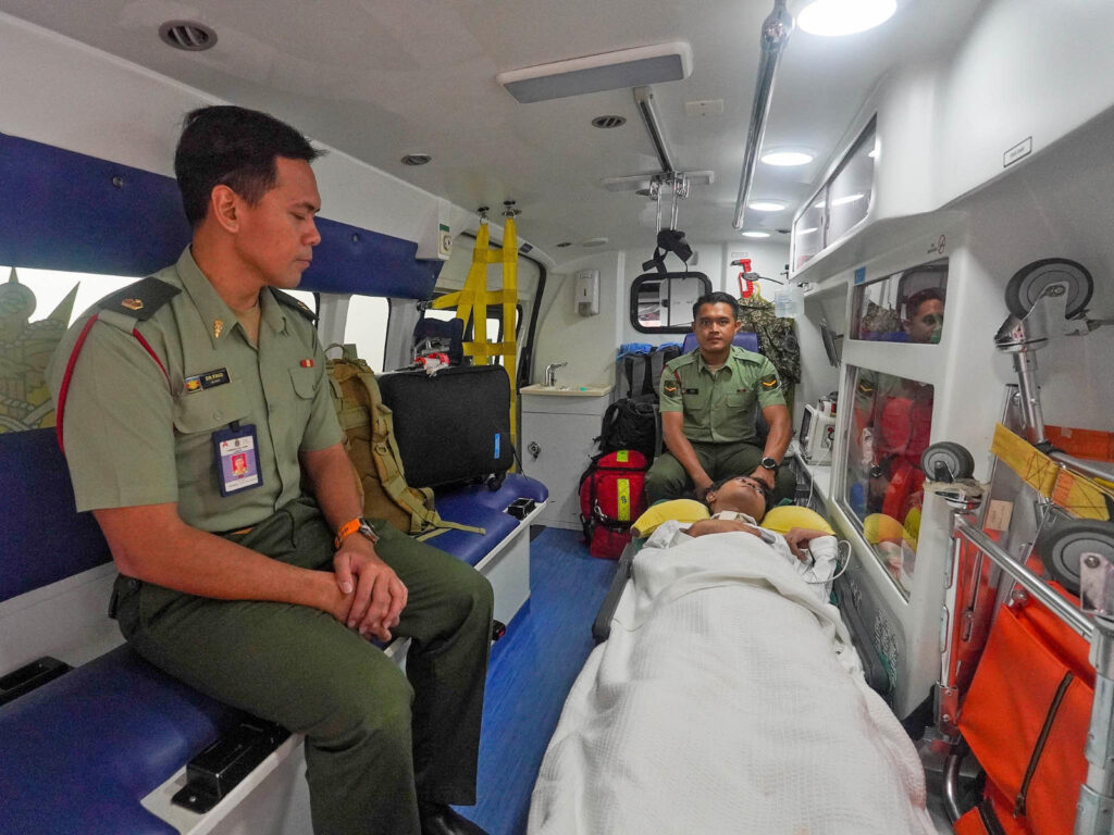 Major (Dr.) Muhammad Faiq Hashim and a 96 HAT medical assistant in the ambulance with Muhammad Afiq on the way to Kemaman