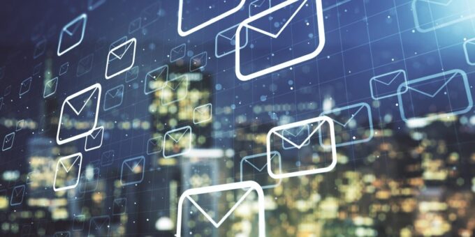 Phishing emails flooding workplace inboxes, illustrated as email icons over a city skyline