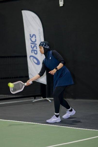 Squash player Aifa Azman playing a backhand shot during World Pickleball Day