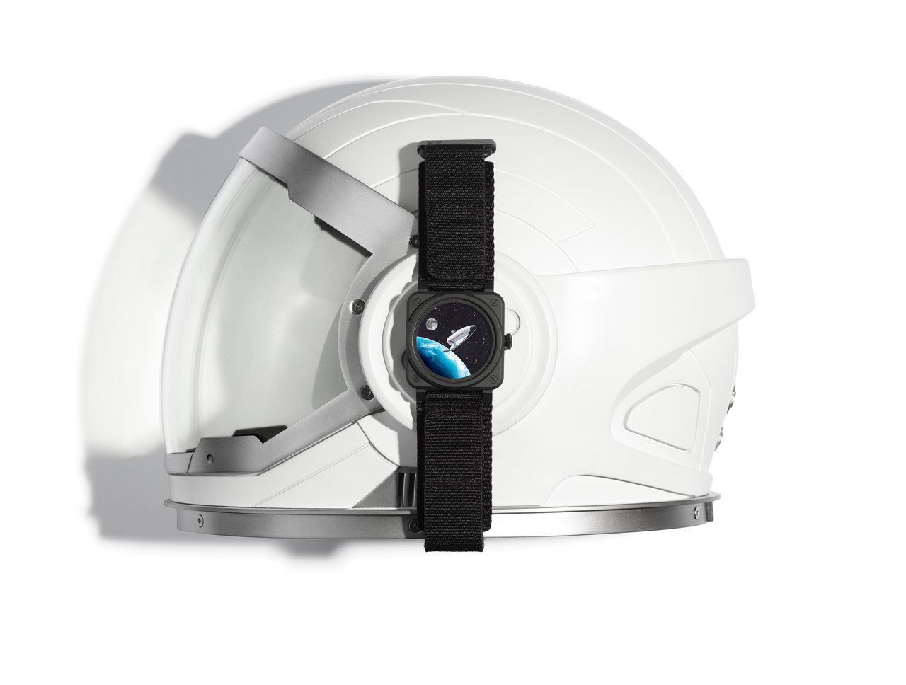 Bell & Ross BR-03 Space Mission watch on a black fabric strap displayed with an astronaut helmet