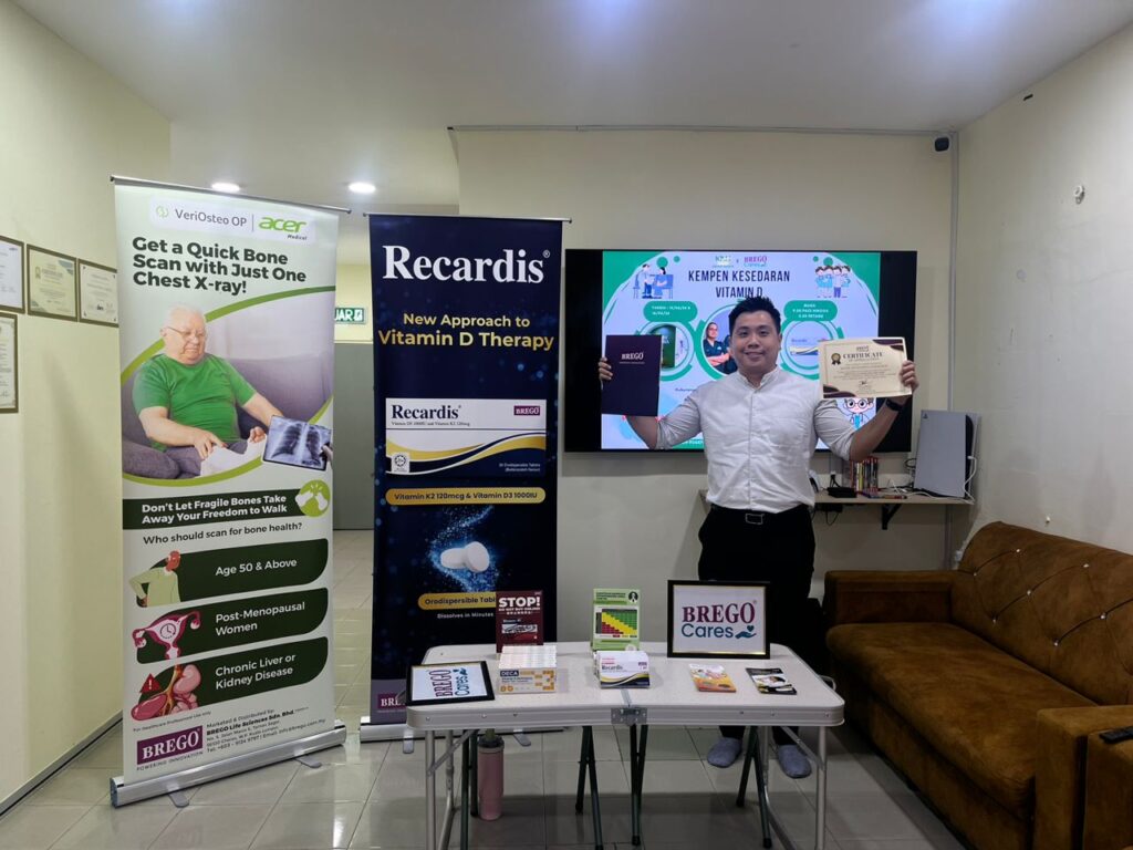BREGO Cares Vitamin D awareness campaign station with VeriOsteo OP bone health screening banner at a clinic