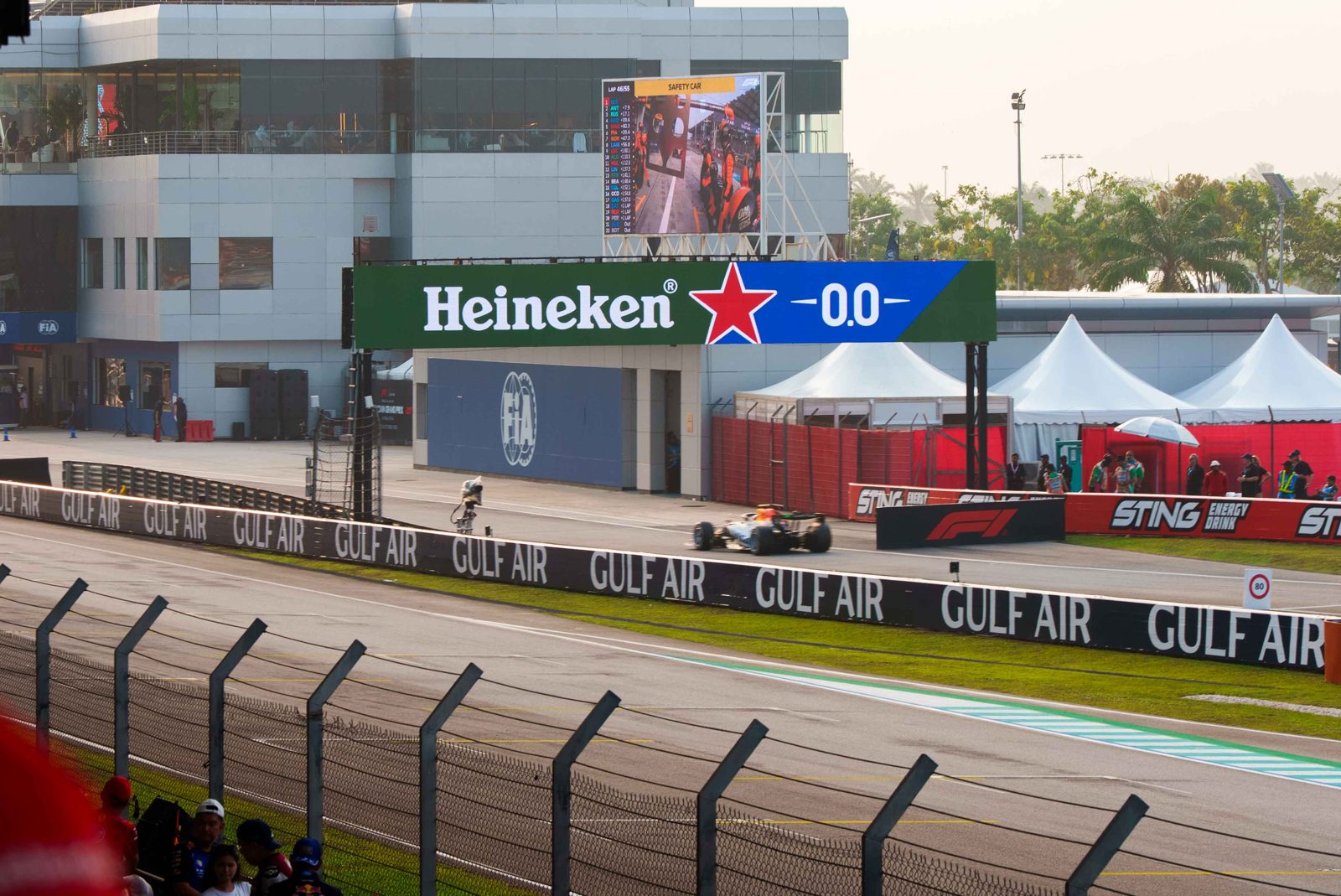 F1 Malaysia 2026 race action at Sepang International Circuit with Heineken 0.0 trackside signage
