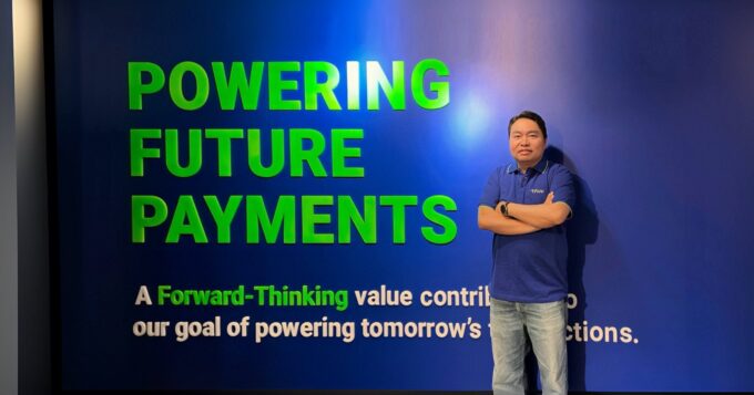 Fiuu CEO Eng Sheng Guan at the Fiuu Powering Future Payments wall