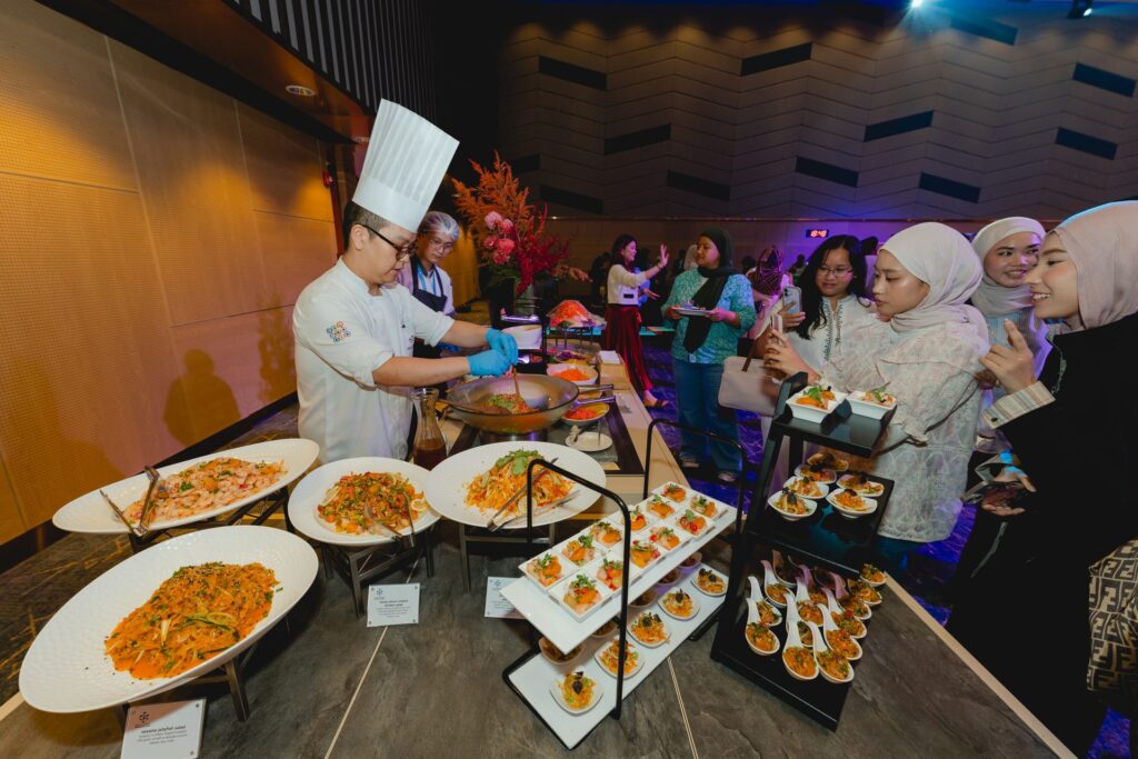 Chef preparing salads at a live station at Flavours of KLCC