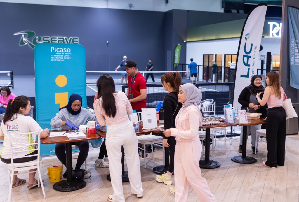 Women registering for basic health screening at the Hospital Picaso booth during the LAC Pink October event