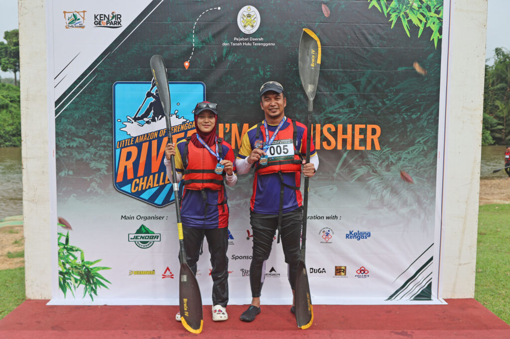 Former national coach Muhammad Hakimi Abdullah and Nur Sarah Adiba Suhaimi with their medals at the Little Amazon of Terengganu River Challenge