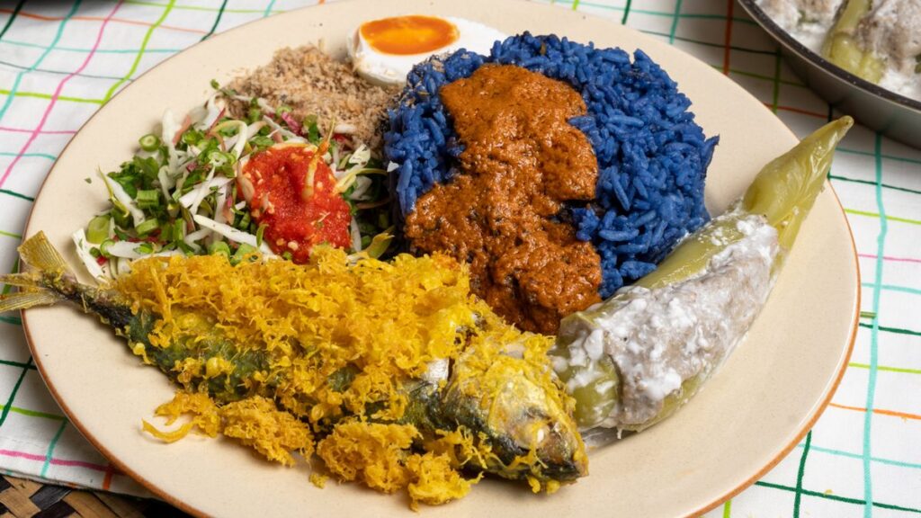Kelantan nasi kerabu blue rice with ulam, sambal and fried fish, an East Coast food highlight along the ECRL
