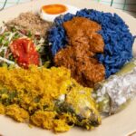 Kelantan nasi kerabu blue rice with ulam, sambal and fried fish, an East Coast food highlight along the ECRL