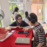 ParkCity Medical Centre audiologist conducting a hearing test for a young participant