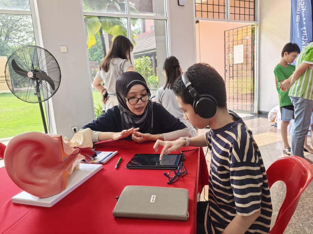 ParkCity Medical Centre audiologist conducting a hearing test for a young participant