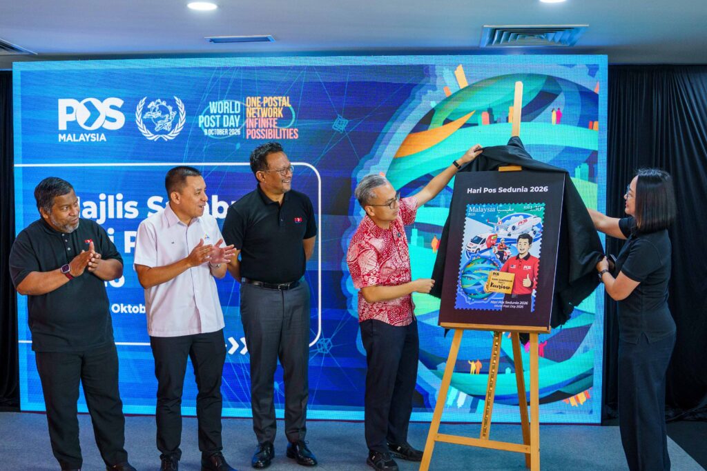 Communications Minister Dato' Seri Fahmi Fadzil unveils the Pos Malaysia World Post Day 2026 commemorative stamp