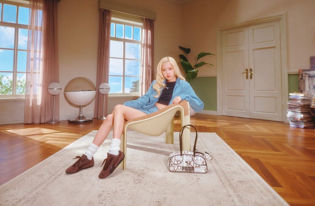 Rosé wearing the PUMA Speedcat Croc in deep brown in a retro interior campaign shoot