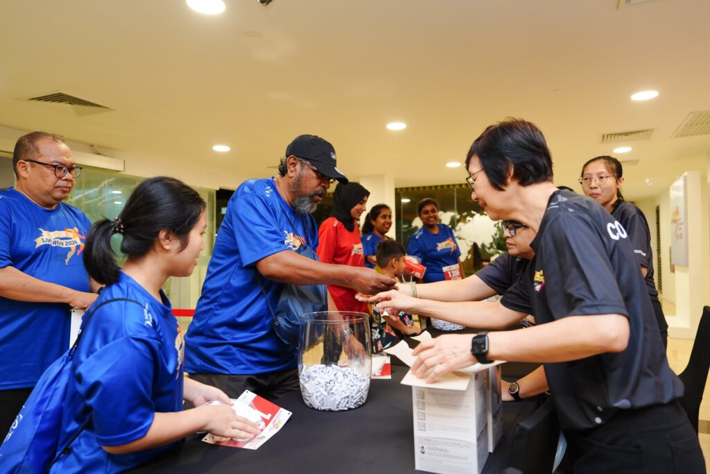 Participants drawing at the lucky dip counter during SJMC Run 2026