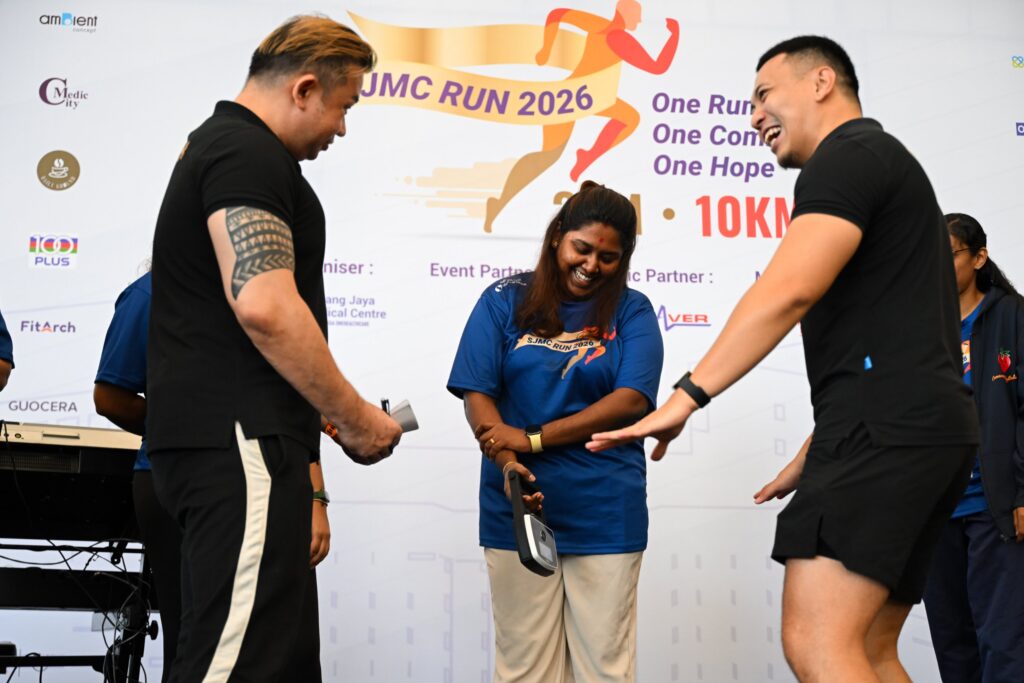 Participant on stage during the prize segment of SJMC Run 2026