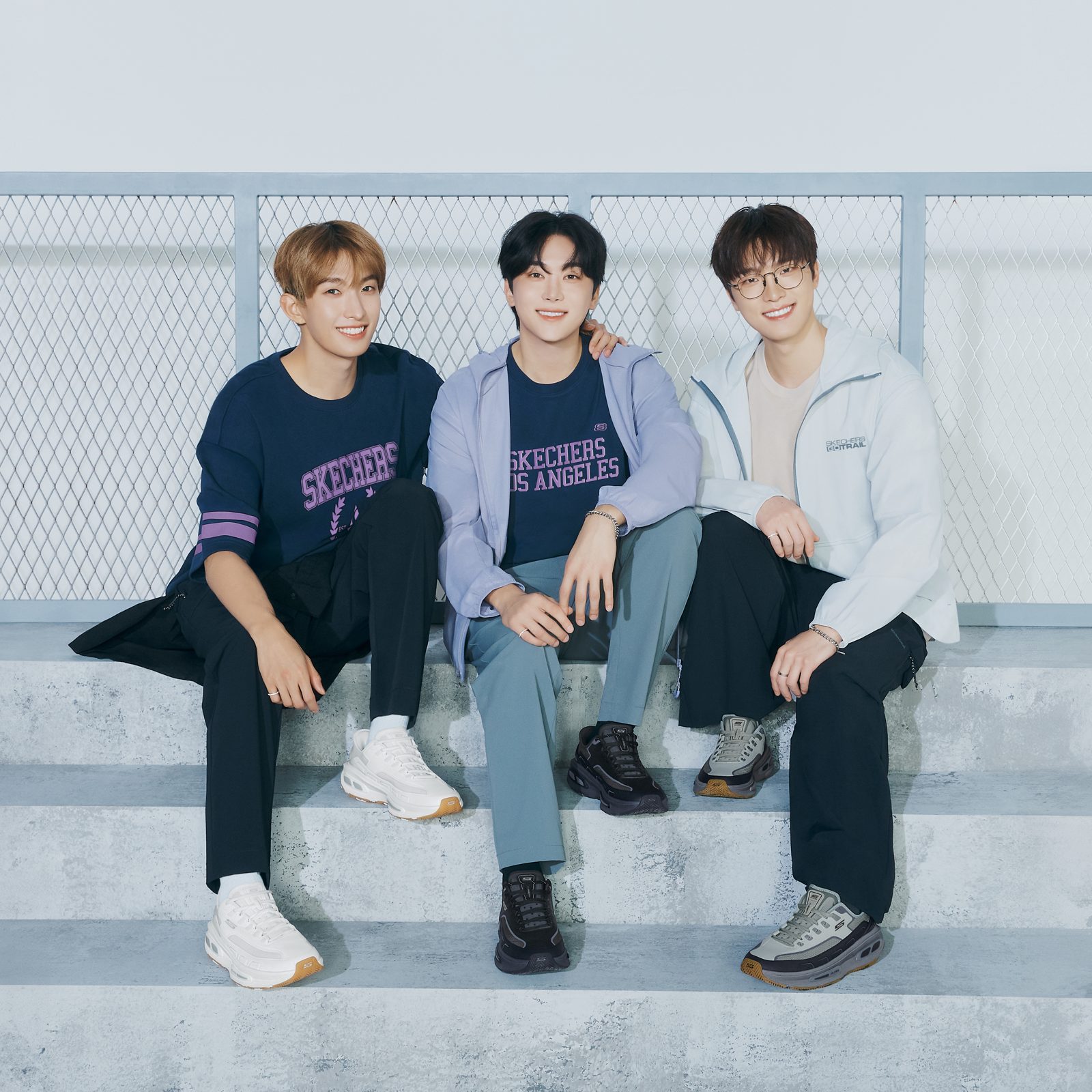 Skechers Arch Fit D'Lites 330 sneakers in white, black and grey worn in a lifestyle shoot