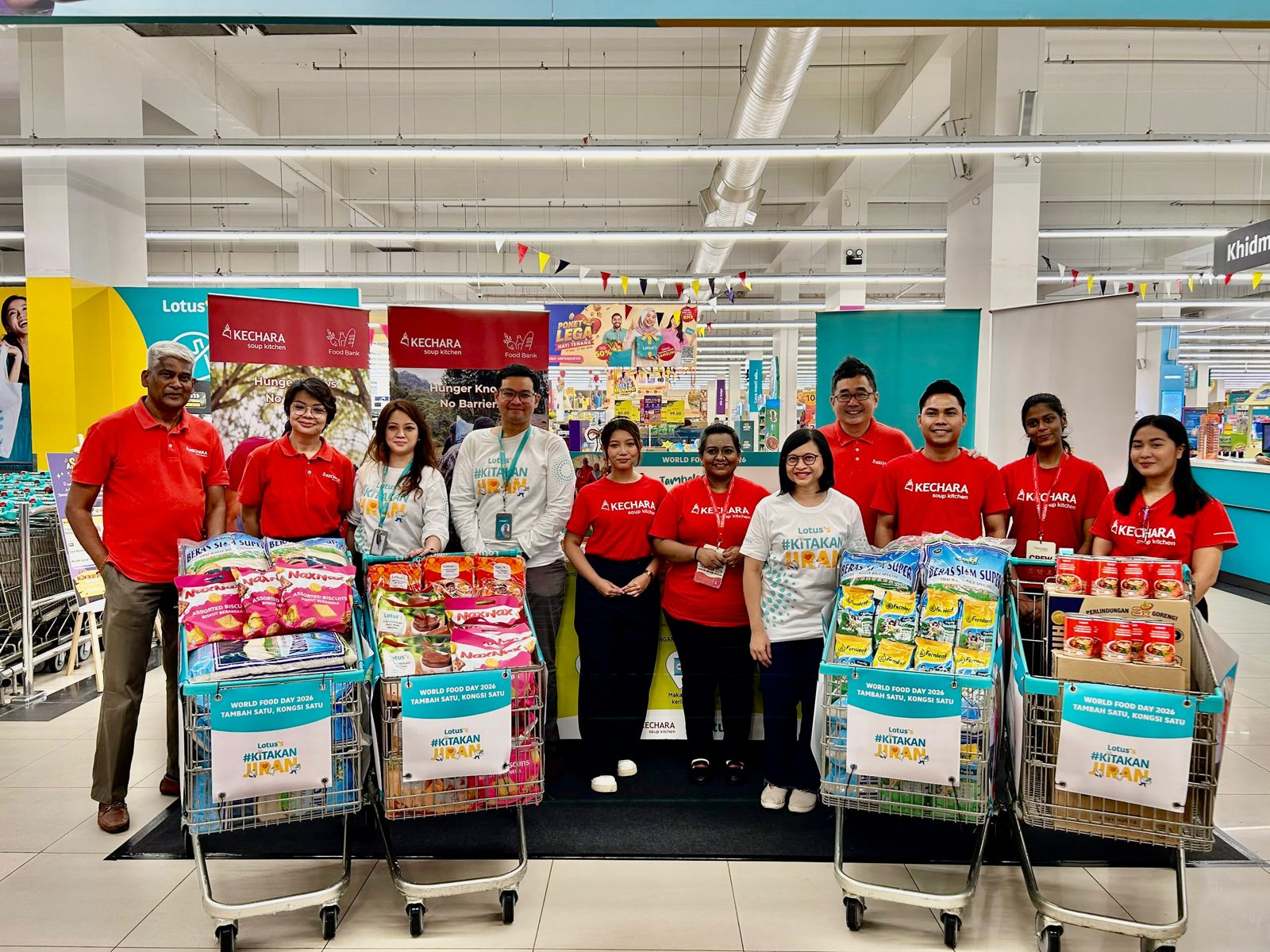 Tambah Satu, Kongsi Satu donation trolleys with Lotus’s Malaysia and Kechara Soup Kitchen representatives