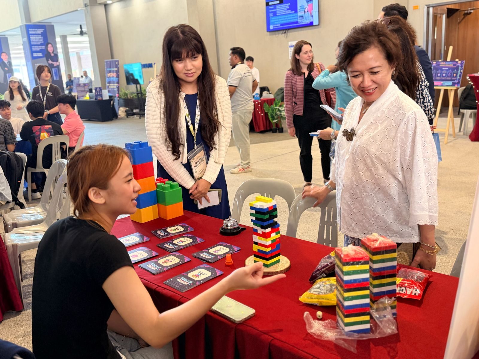 Professor Adeeba Kamarulzaman visiting a student wellbeing exhibition booth at Thrive Together 2026
