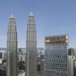 W Kuala Lumpur hotel tower beside the Petronas Twin Towers in the Kuala Lumpur skyline